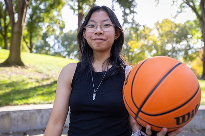 a teenager holding a basketball