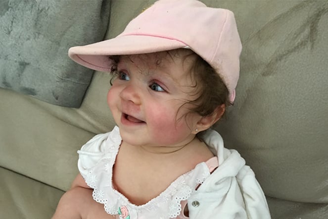 a baby wearing a pink hat