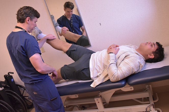 a doctor examining a patient's leg