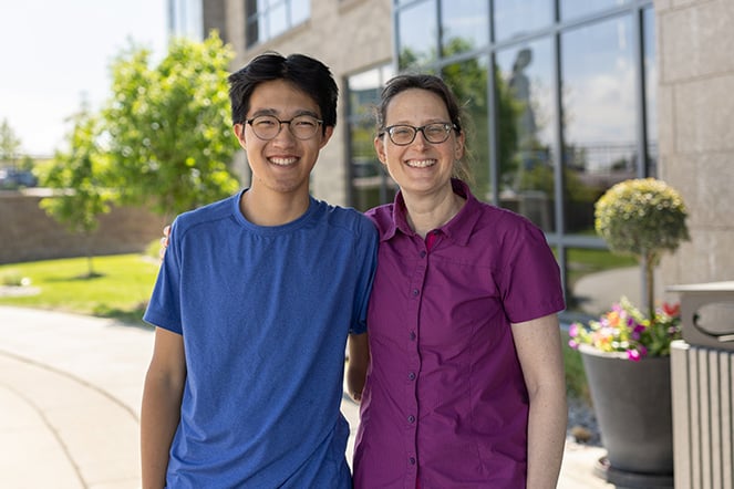 a mother and son outside of a building