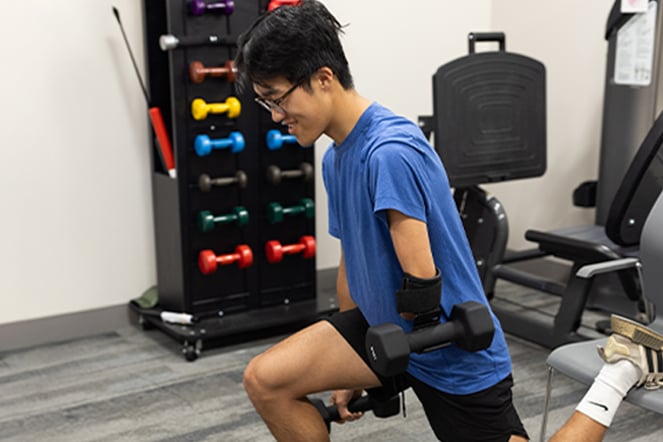 an athlete doing a lunge with an adaptive device on his arm