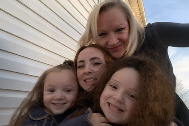 a group photo of two women and two young girls