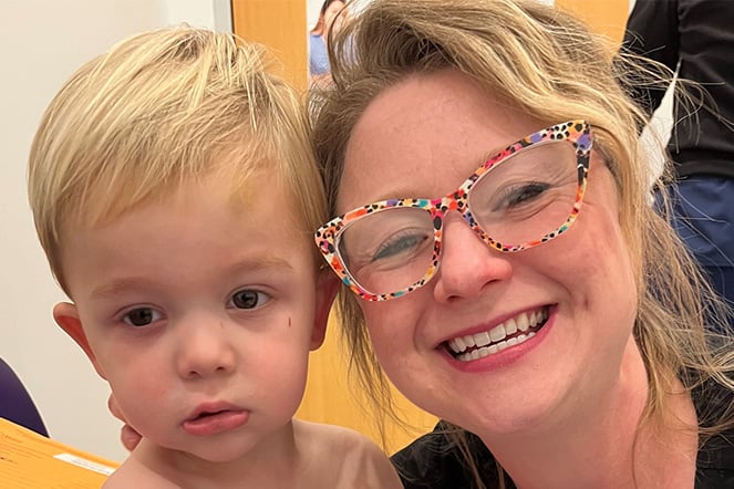 a woman smiling with a young child