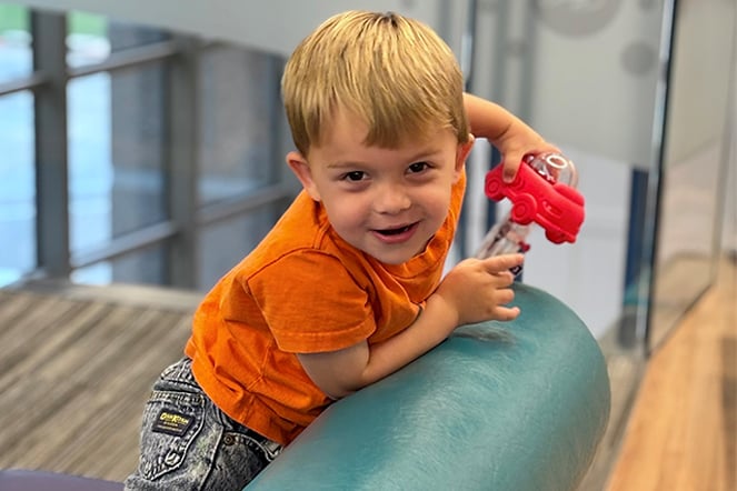 a child laughing on a couch