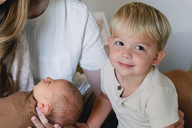 a portrait of a young child and his infant brother