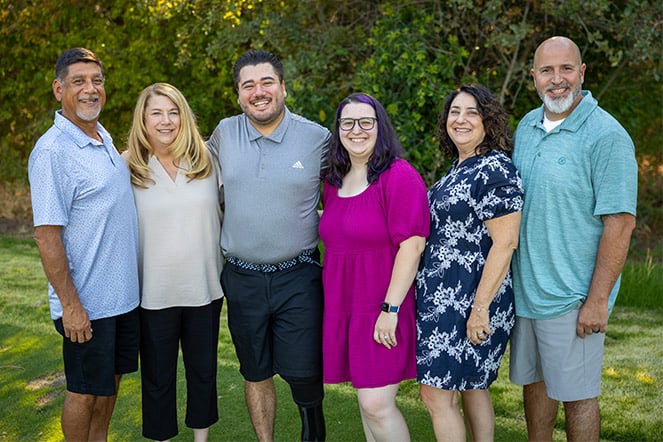 a group of adults smiling outside