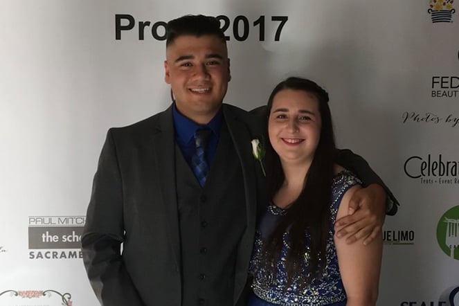 two people in front of a photo backdrop