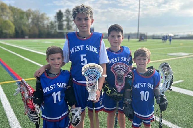 four brothers wearing matching lacross uniforms