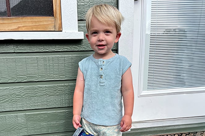 a young child standing in front of a glass door