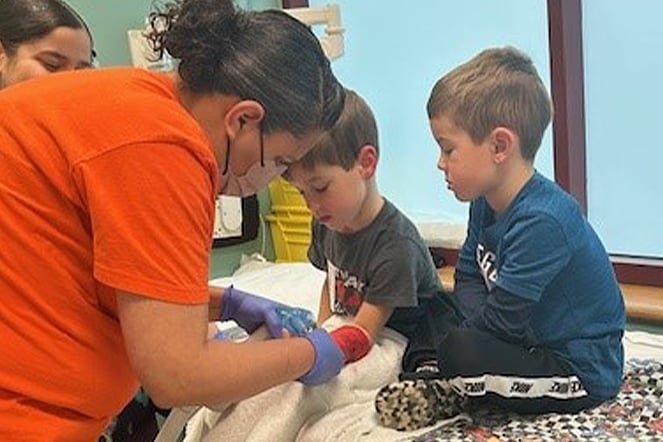 two young children sitting during a casting appointment