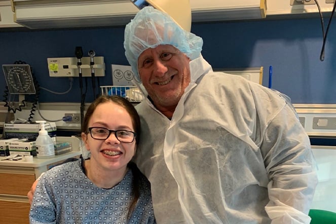 an adult man and a child in a hospital room