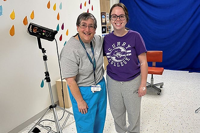 a woman and teenager in a photography studio