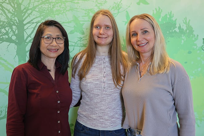 a teenager with two adults by her side
