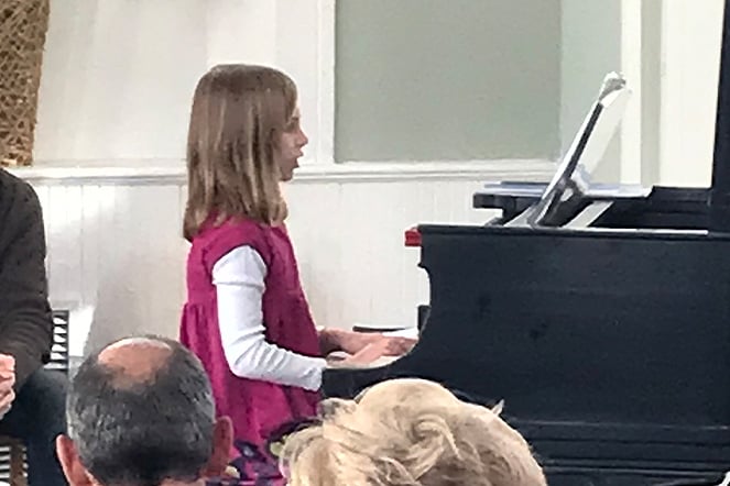 a young child playing piano