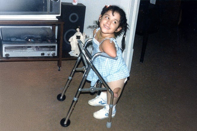a vintage photo of a young child with a walker