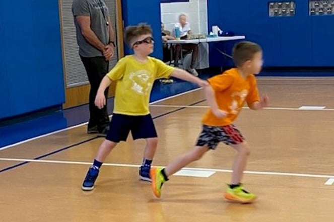 two children playing basketball