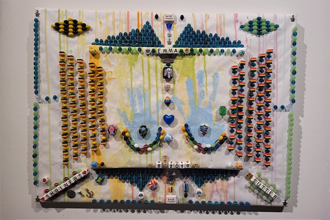 a mixed media art project with paint and beads