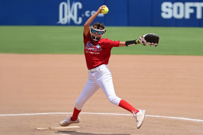a youth softball pitcher throwing a softball