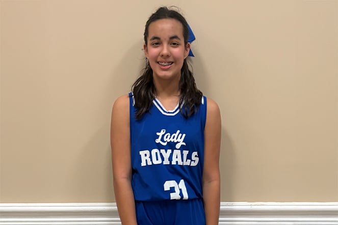 a young girl wearing a basketball uniform