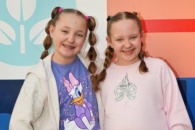 two smiling twin sisters