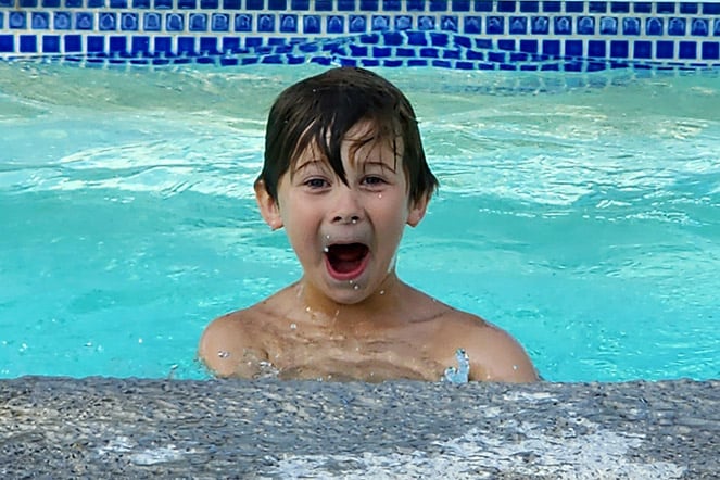 a child laughing in a pool
