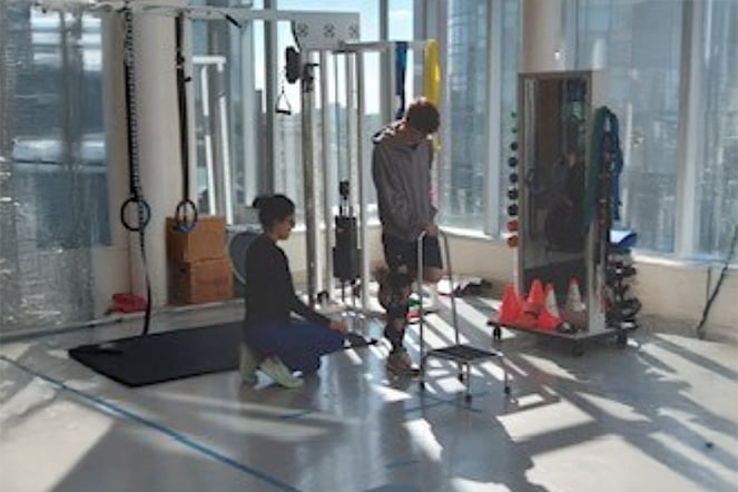 two people in a physical therapy room