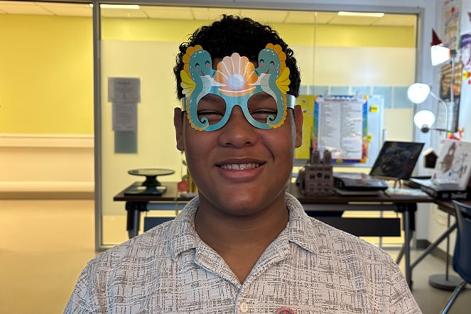 a teen wearing silly glasses