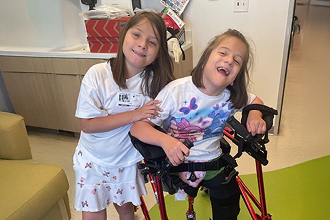 two children laughing in a hospital lobby