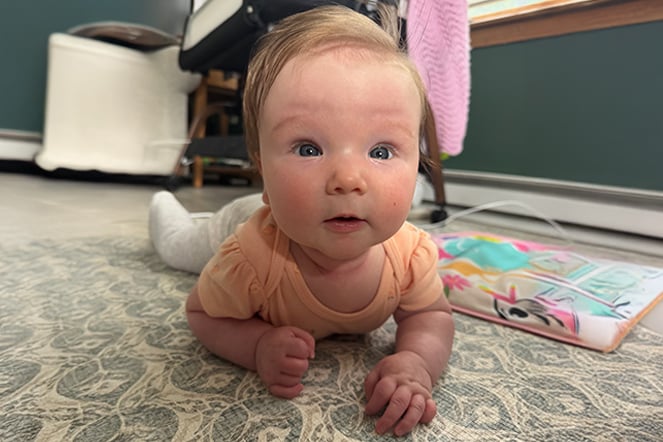 a young child lying on a rug