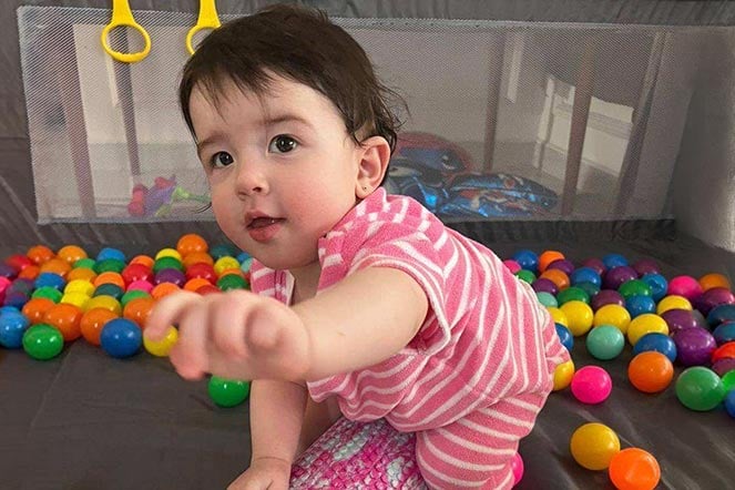 female child playing in ball pit