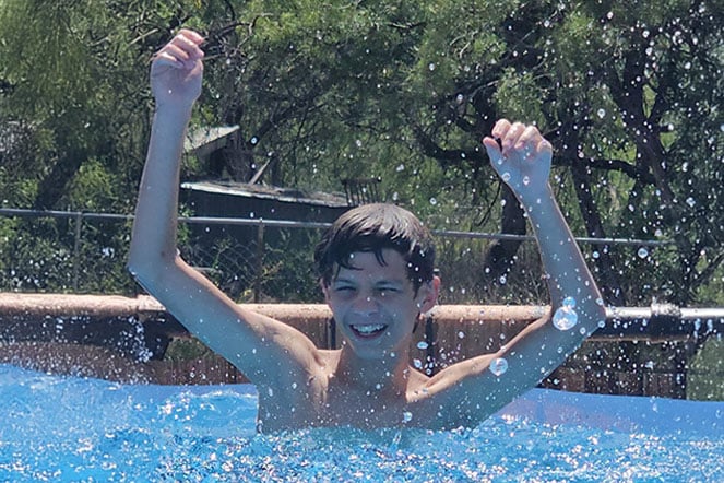 a child splashing in a pool