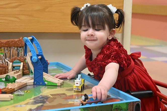 female child with cerebral palsy playing