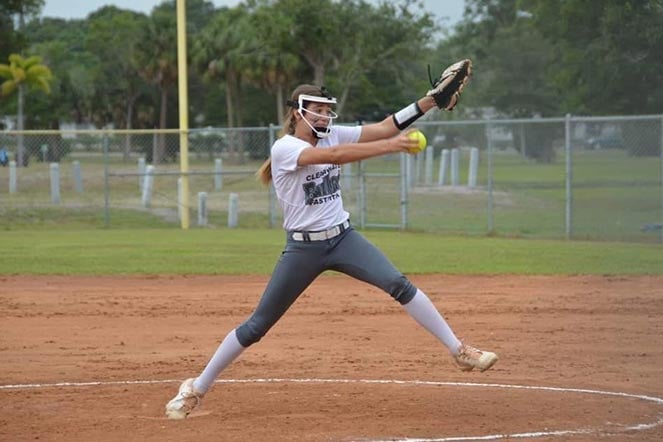 female softball player pitching the ball