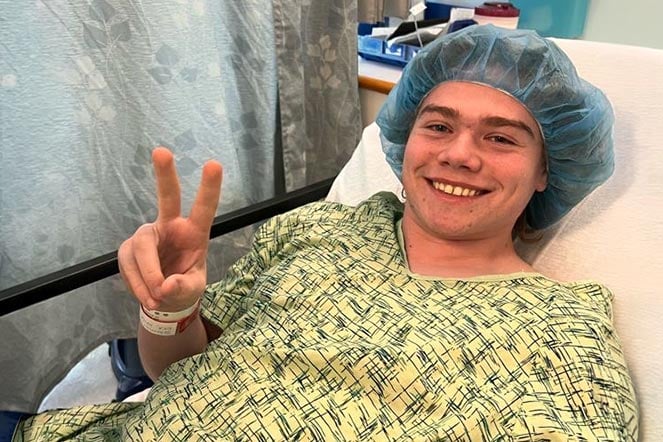 patient in hospital bed wearing pre-op attire