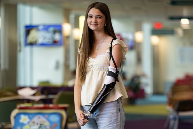 a portrait of a child with a prosthetic arm
