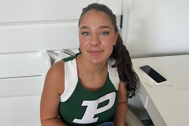 a cheerleader sitting at a table 