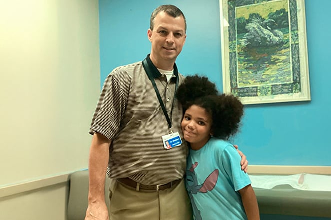 a child hugging an adult in a hospital examination room