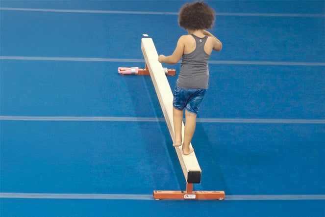 a child walking on a balance beam