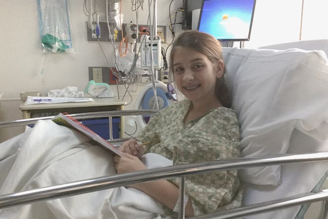 a smiling child in a hospital bed
