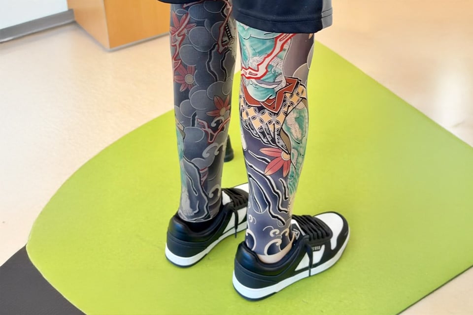 prosthetic lets with elaborate tattoo designs on them
