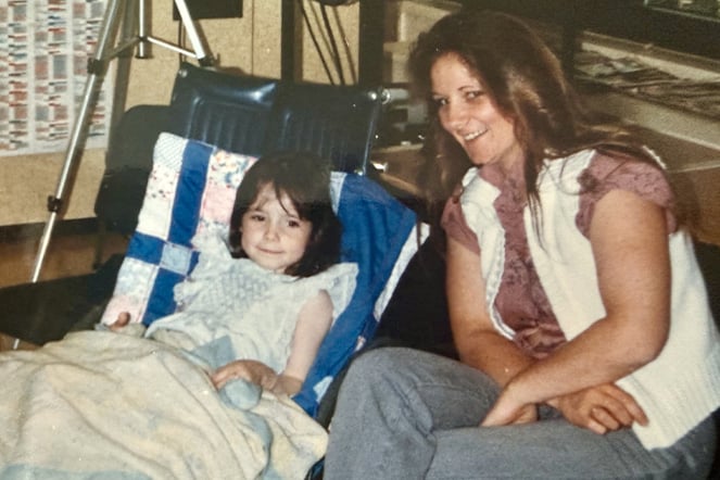 a vintage photo of a child in a wheelchair and her mother