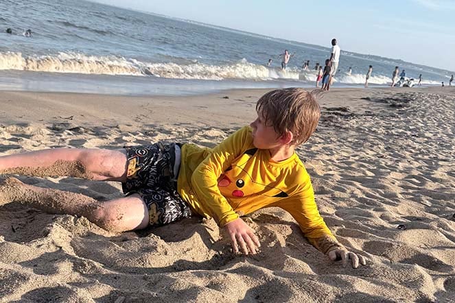 burn patient relaxes on the beach