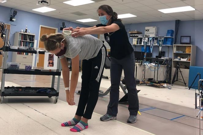 provider measures patient scoliosis curve
