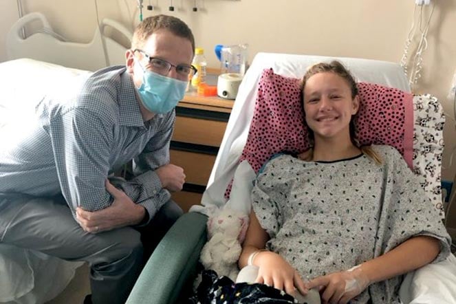 provider visits scoliosis patient during spinal fusion surgery recovery