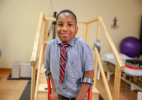 male patient on crutches during therapy session