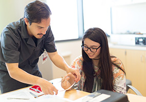 orthotist/prosthetist measures patient hand