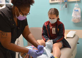 masked staff member and patient