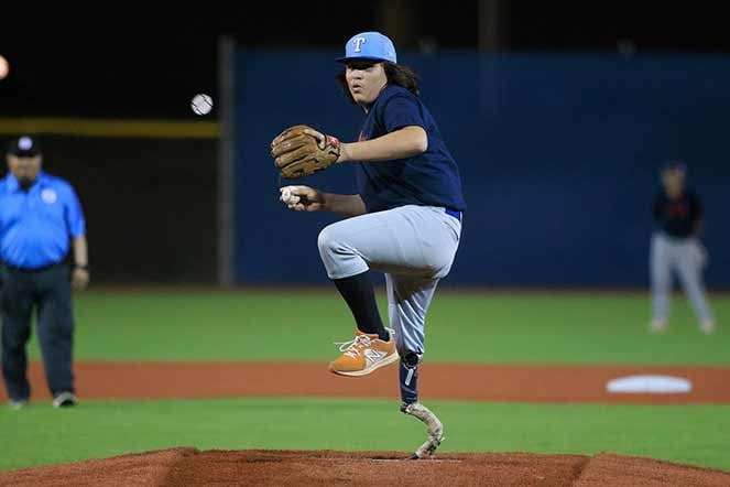 Adison pitching from pitcher's mound during ball game