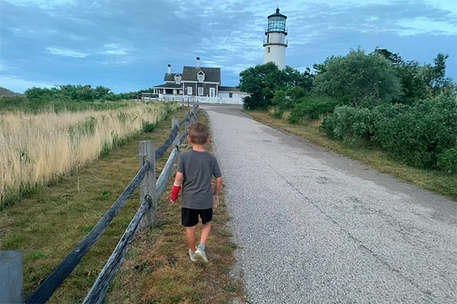 Aksel walking towards a lighthouse.