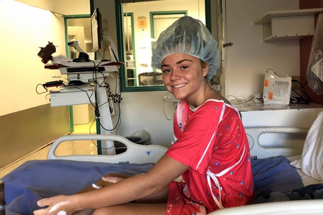 Allie in hospital bed before spinal fusion surgery